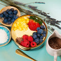 Sweet cup - tropische gelbe Mango-Smoothie-Bowle mit Chia Samen, Kokosflocken und Himbeeren